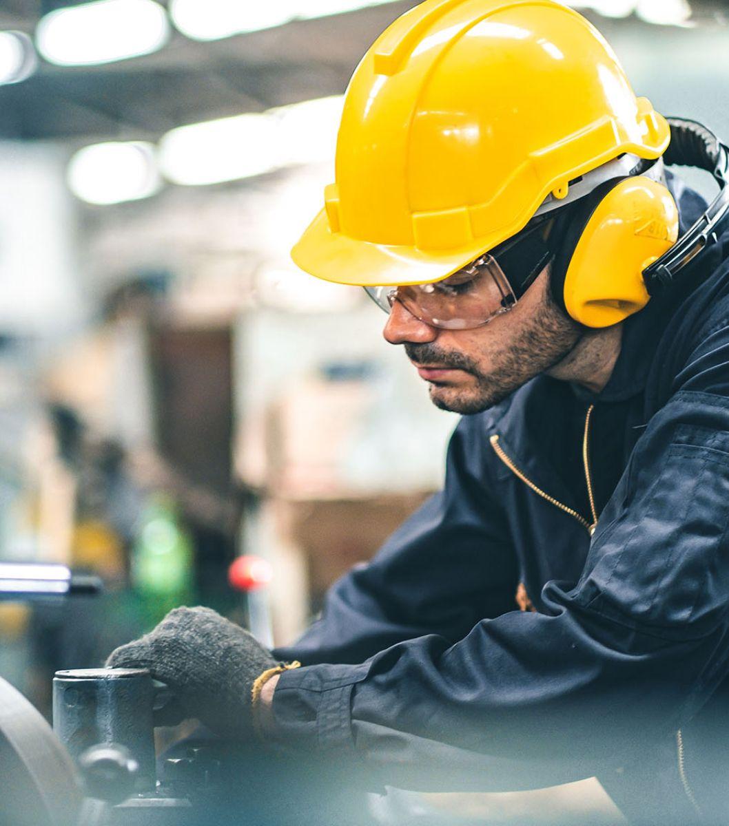 Man wearing yellow hard hart working