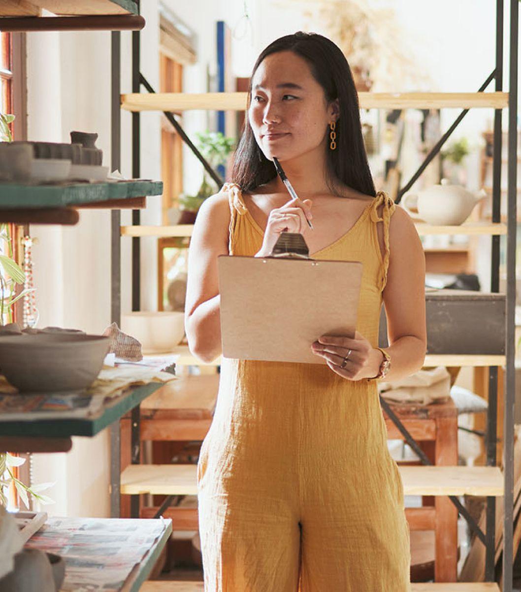 Women wearing a yellow outfit holding a clipboard.