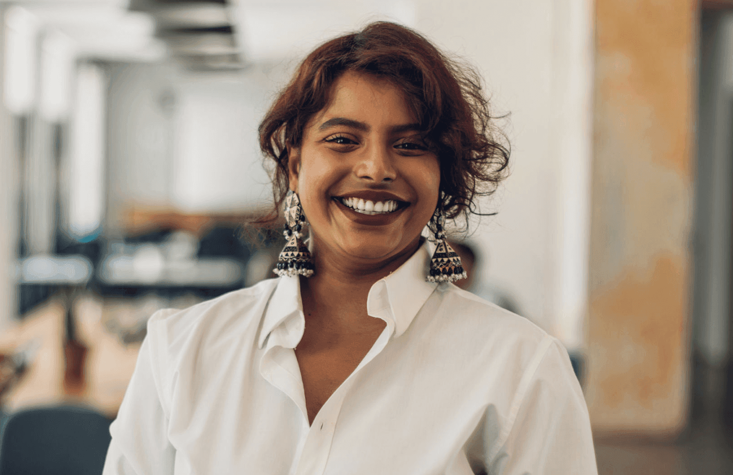 woman smiling in white shirt